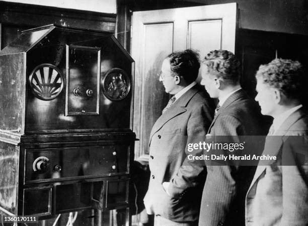 First BBC television transmissions, 1929. Photograph showing television experts watching the Baird system transmitting the first BBC broadcast. John...