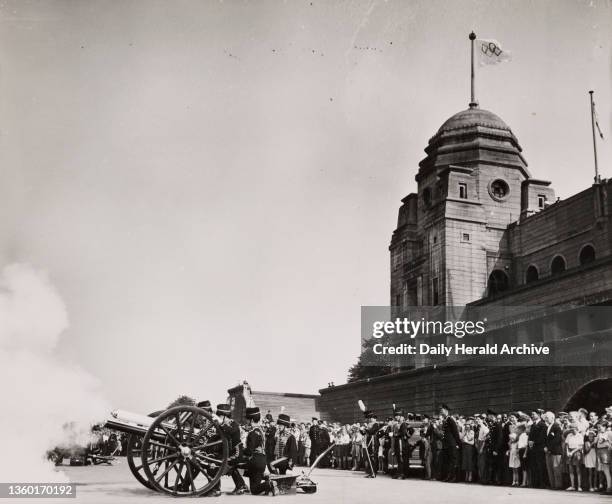 Cannon being fired outside Wembley Stadium, Olympics, 1948. British soldiers firing cannon, watched by crowds at London’s Wembley Stadium. The...