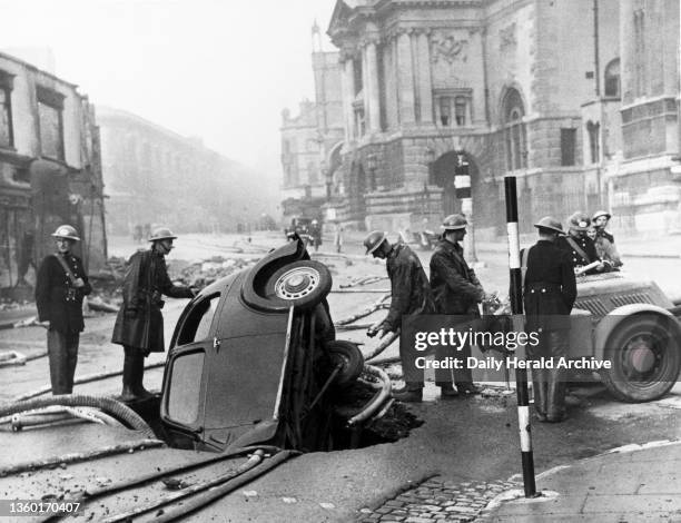 Motor car in a bomb crater, Bristol, Second World War, 18 March 1941". ‘This car was unable to stop and fell into the bomb crater, following a German...