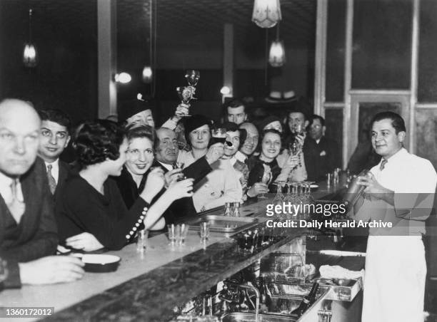 As John Barleycorn returned to Quaker City, 6 December 1933. A group at the Chatter Club. Buying liquor across the bar is strictly taboo in...
