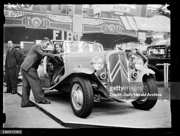 Demonstrating a Citroën sports car, 1933. A photograph of a Citroën Traction 11 Cabriolet on display at the Motor Show in Olympia, London, taken by...