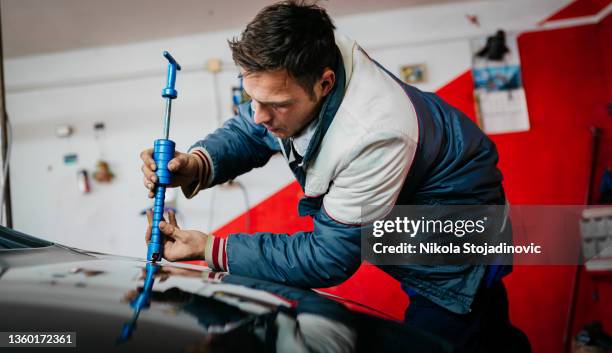 auto body mechanic disassembling damaged vehicle - dents stock pictures, royalty-free photos & images