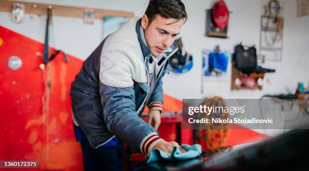 technician using protective gloves is in process of paintless dent repair on car - auto body stock pictures, royalty-free photos & images