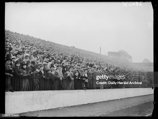 Huge crowd watch a football match between Charlton and Chelsea, 1937. A photograph of a part of a huge crowd watching a match between Charlton and...