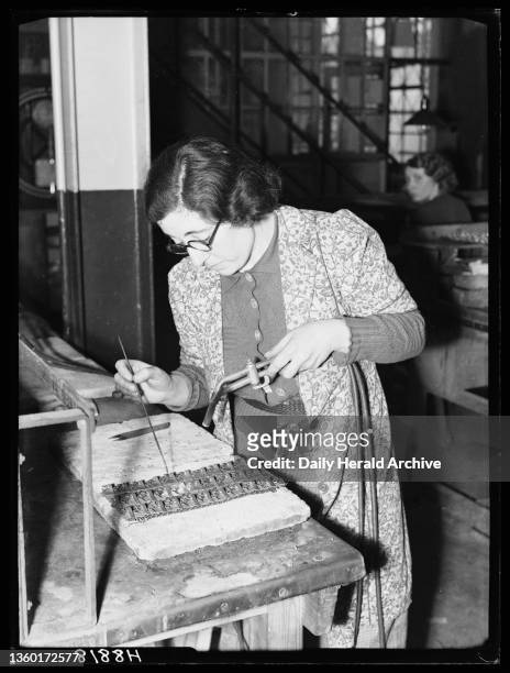 Badge making, 1940. A photograph of a woman making badges for the army, taken by Bishop Marshall for the Daily Herald newspaper on 8 January, 1940....