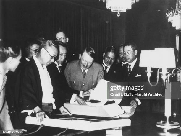 Adolf Hitler receiving gifts from Japanese statesmen visiting Berlin for the 1936 Olympic games. A photograph of Adolf Hitler receiving gifts of...