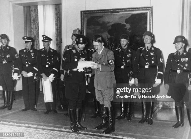 Adolf Hitler with Heinrich Himmler and Gestapo chiefs in 1937. A photograph of Adolf Hitler with Heinrich Himmler and Gestapo chiefs in 1937.