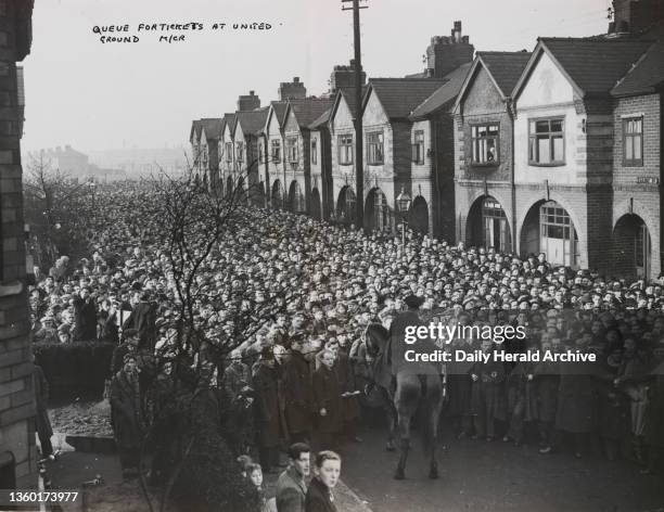 Scene after stampede for tickets to see football club Manchester United'. A photograph showing the scene after a stampede for tickets to watch...