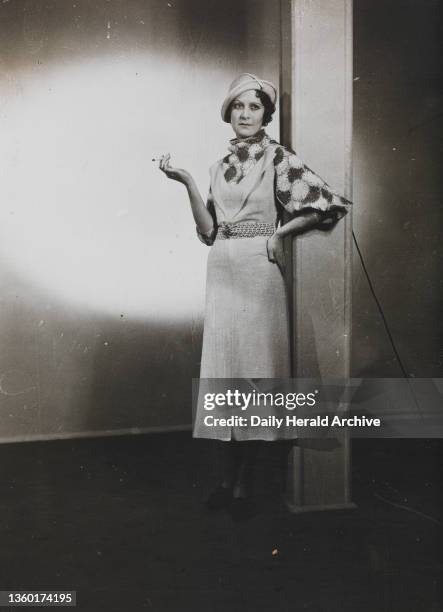 Advance Matita models, 1934. A simple linen frock with elbow sleeves & swathed throat wrap. Photograph by Edward G Malindine.