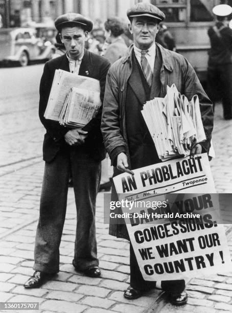 Vendors selling anti-British newspapers on the streets of Dublin, Republic of Ireland, 25 May 1937. An anti-British poster is seen here displayed in...