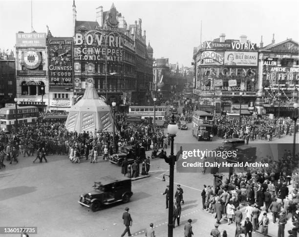 Crowds in Piccadilly Circus celebrating the eve of V E Day, 7 May 1945. Photograph by F Greaves.