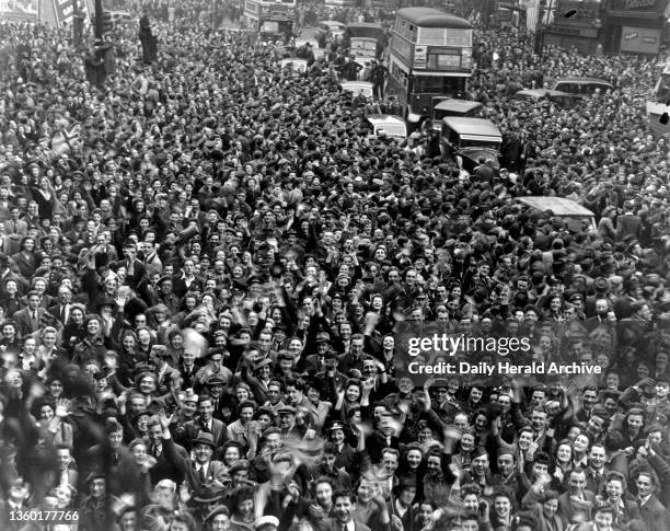 Crowds in Piccadilly Circus in Central London, celebrating on the eve of VE Day, 7 May 1945. Photograph by F Greaves.