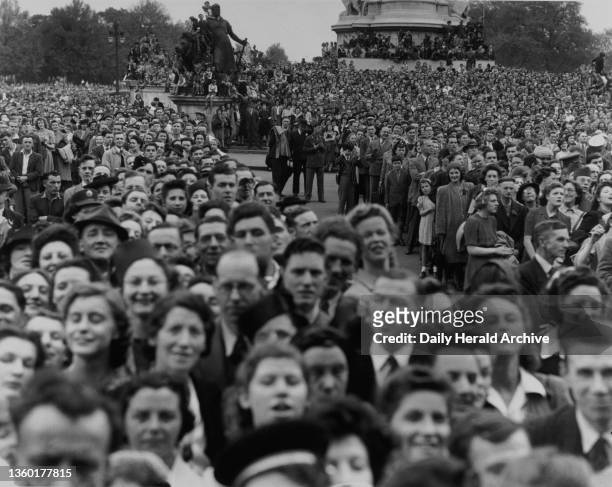 Crowds outside Buckingham Palace celebrating V E Day, 8 May 1945. Photograph by F Greaves.