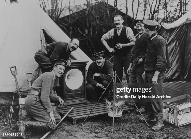 British Soldiers with their Christmas gift of a gramophone, France, 1914-1918. Jollity and good fellowship is nowhere stronger than at the Front....