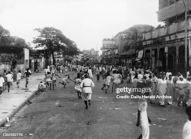 Lone policeman charges mob, Calcutta, circa 1945. 'A lone policeman armed with a lathi breaks up a mob, and soon the city of Calcutta is aflame with...