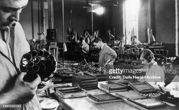 Manufacturing lenses at Kodak, circa 1930s. 'High- class lenses, at one time almost a foreign monopoly, are produced by the thousand at the Kodak...