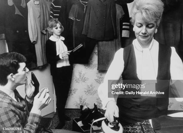 Patrick Kerr and Theresa Confrey; dancers in the TV show Ready Steady Go are about to be married. 'Mrs Confrey irons whilst Pat Kerr shoe shines and...