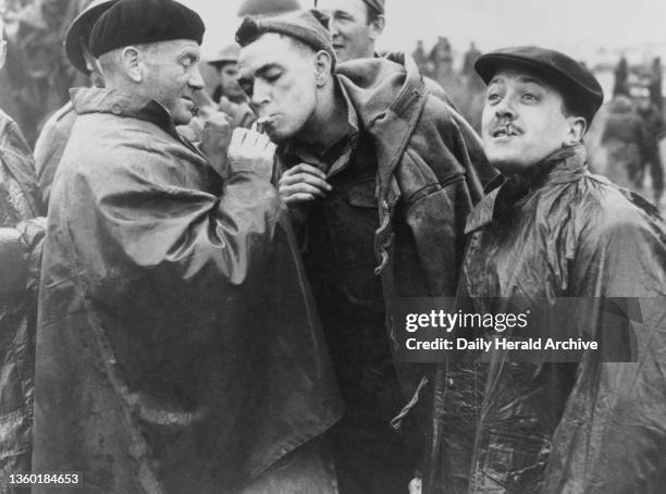 On the set of Dunkirk in Camber Sands, Sussex. On the set of Dunkirk in Camber Sands, Sussex. John Mills as Tubby Binns gives a light to one of the...
