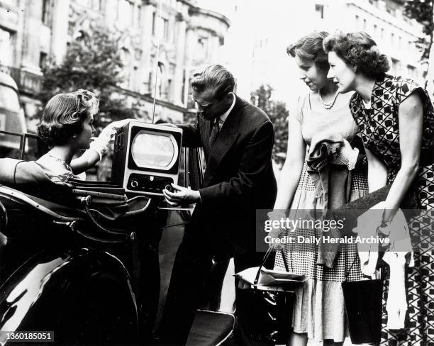 The EKCO television, the first British portable television receiver, 1955. Photograph shows a working EKCO portable television set perched on an...