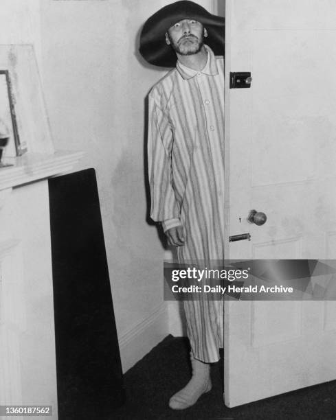 Spike Milligan in a nightshirt and floppy hat, 1958