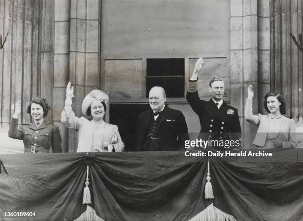 The Royal Family and Winston Churchill greet the people from Buckingham Palace balcony' 8th May 1945. The King and Queen, the two princesses and Mr...