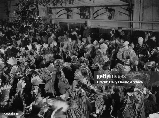 The Lord Mayor of London hold a Christmas party for poor children at H A C Headquarters, 20 December 1932. A general view of the party with clowns...