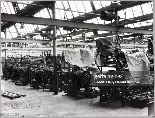 Nelson Mill, Lancashire, famous for its cotton products is slowly dying through a slackening off of Textile orders. The scene in a mill weaving shed...