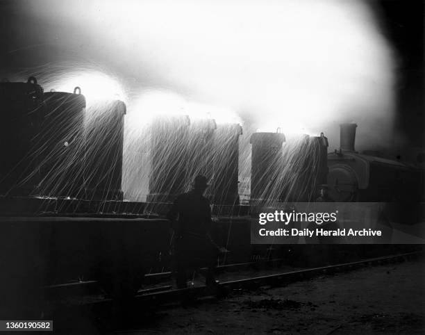 Train leaving the Bessemer plant loaded with molten steel, Stewart & Lloyd's Steel and Tube Works, Corby, 19 December 1935. Photograph by Harold...