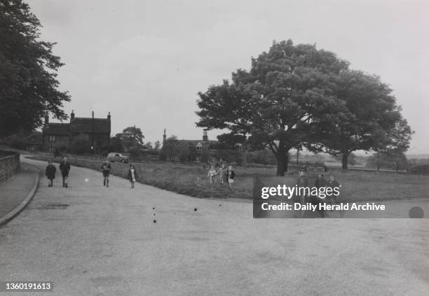 Sale of Woolley Village, near Wakefield, Yorks, 1949. Woolley village green with schoolchildren walking home.