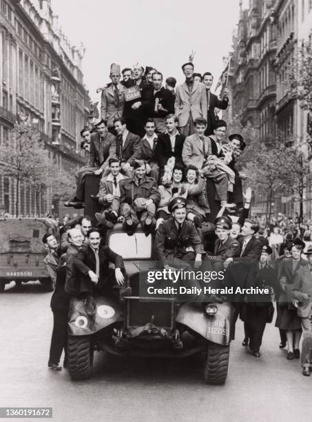 Crowd swarming all over a lorry on VE day. World War Two: VE Day. Crowd swarming all over a lorry on VE Day, central London, 8 May 1945.