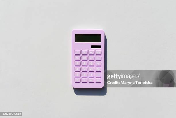 purple calculator on a universal gray background. gray background. calculator in magenta color. - calculadora imagens e fotografias de stock