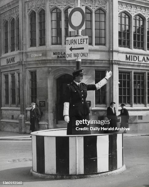 Zebra' Control, 1952. Zebra stripes are transferred from the road to the policewoman's 'tub' to give a Continental touch to this traffic control...