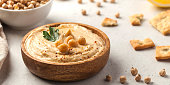 Banner hummus of their chickpeas in a wooden plate. Vegetarian food