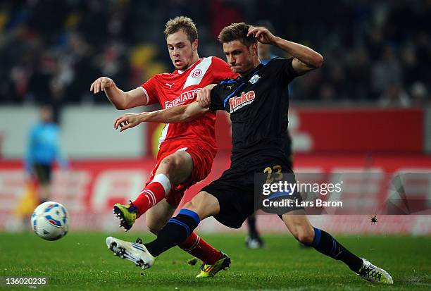 Maximilian Beister of Duesseldorf is challenged by Markus Palionis of Paderborn during the Second Bundesliga match between Fortuna Duesseldorf and SC...