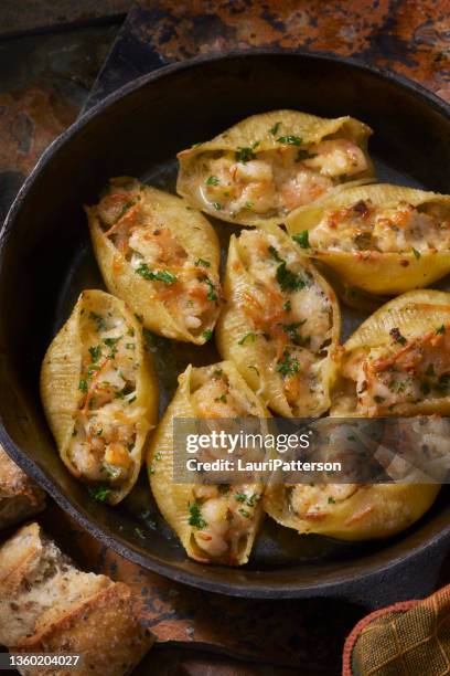 cheesy shrimp scampi stuffed pasta shells - bechamel sauce stock pictures, royalty-free photos & images