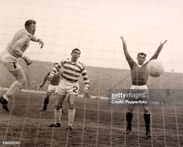 Glasgow Celtic goalkeeper Frank Haffey , Duncan MacKay of Celtic and Ralph Brand of Rangers watch the ball enter the net for Glasgow Rangers' first...