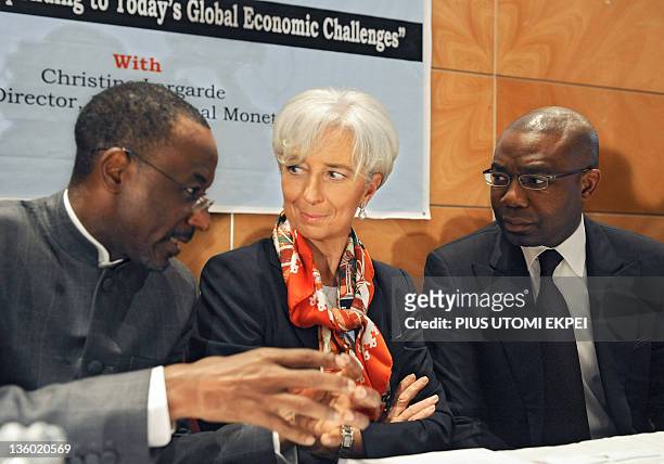 Managing Director Christine Lagarde flanked by Nigeria's Central Bank Governor Lamido Sanusi Lamido and CEO Access Bank, Aigboje Aig-Imoukhuede talk...