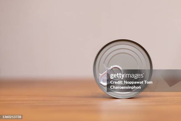 view of canned tuna on the side showing easy-opened end on wooden surface, bangkok, thailand - tuna stock pictures, royalty-free photos & images