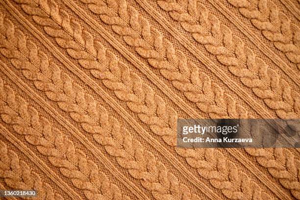 texture of warm knitted sweater. backdrop in brown color. - maglione foto e immagini stock