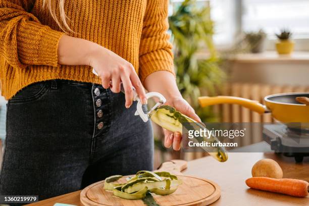 peeling off a cucumber - peeled stock pictures, royalty-free photos & images