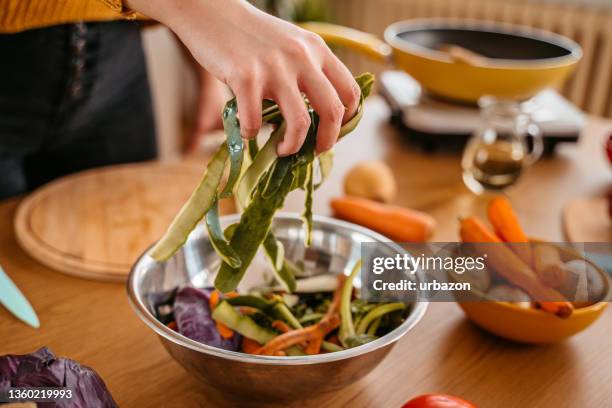 collecting vegetable leftovers for compost - leftovers stockfoto's en -beelden