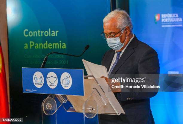 Portuguese Prime Minister Antonio Costa wears a protective mask as he arrives to brief the press to announce new mitigation measures at the end of...