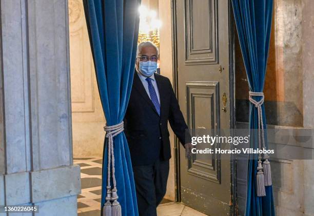 Portuguese Prime Minister Antonio Costa wears a protective mask as he arrives to brief the press and announce new mitigation measures at the end of...