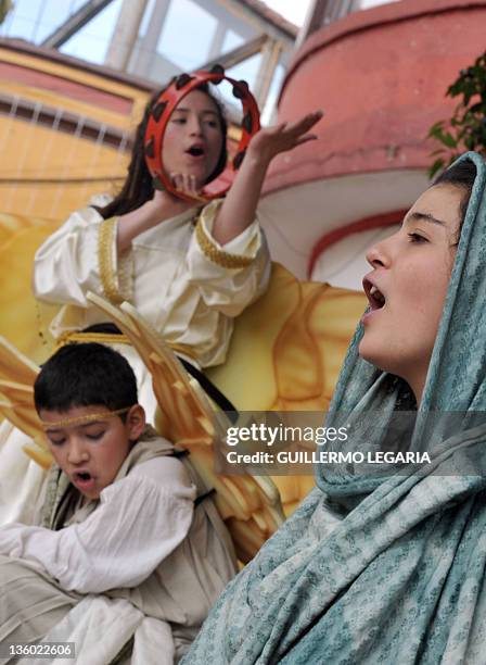 Group of children pray the Christmas Novena while recreating a living Nativity scene on December 16 at the Chorro de Quevedo Square in the...