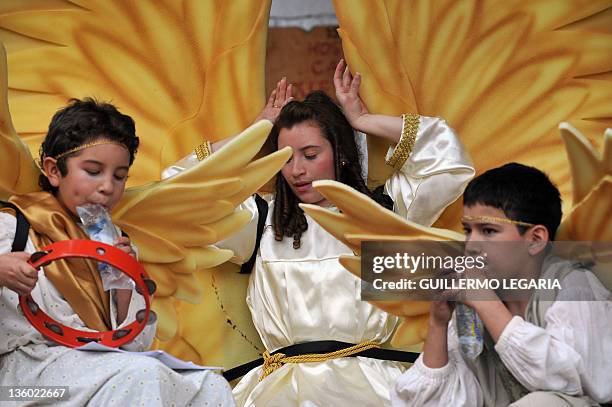 Group of children pray the Christmas Novena while recreating a living Nativity scene on December 16 at the Chorro de Quevedo Square in the...