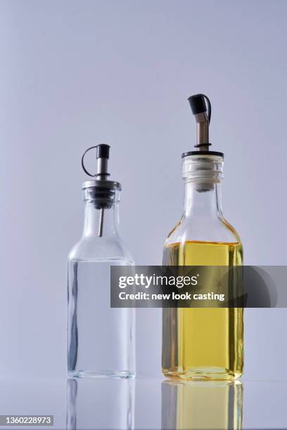 white vinegar and olive oil against white background - white vinegar stock pictures, royalty-free photos & images