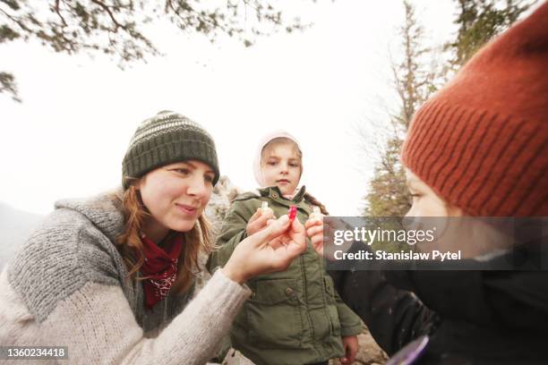 mother with daughters having fun on trip eating gummy bears - bonbon stock-fotos und bilder