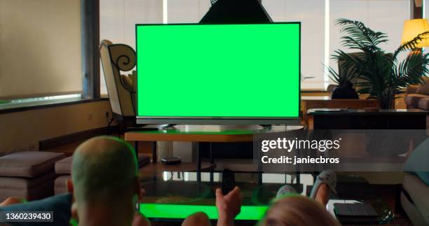 rear view of friends watching intense sports match. big tv screen with chroma key. - chroma key stock pictures, royalty-free photos & images