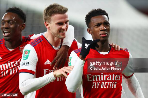 Eddie Nketiah of Arsenal celebrates with teammates Rob Holding and Folarin Balogun of Arsenal after scoring their team's first goal during the...