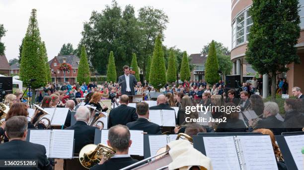 audience listening to a free outdoor concert of the local orchestra - music conductor stock pictures, royalty-free photos & images